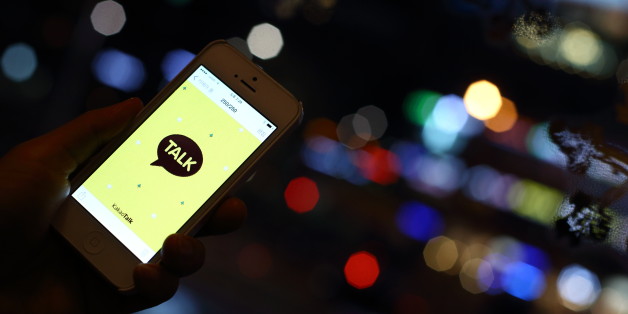 The logo of KakaoTalk, a messaging app developed by Kakao Corp., is displayed on an Apple Inc. iPhone 5 in this arranged photograph taken in Seoul, South Korea, on Saturday, Dec. 28, 2013. Kakao is South Korea's biggest mobile messenger operator. Photographer: SeongJoon Cho/Bloomberg via Getty Images