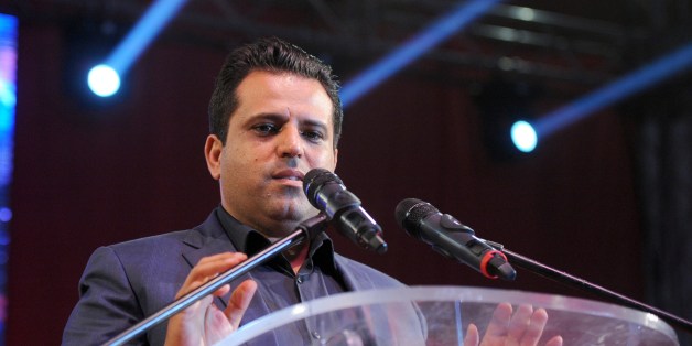 Tunisian founder and president of the Free Patriotic Union, Slim Riahi delivers a speech to his supporters during a campaign meeting in the Mellassine city, a poor neighborhood of Tunis on October 24, 2014. Tunisians vote on October 26, 2014 to elect their first parliament since the country's 2011 revolution, in a rare glimmer of hope for a region torn apart by post-Arab Spring violence and repression. AFP PHOTO / FETHI BELAID (Photo credit should read FETHI BELAID/AFP/Getty Images)