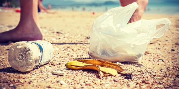 Vintage instagram style picture of garbage left by tourists on a beach, environmental pollution concept picture.
