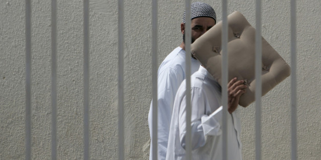 Suspects arrive for a trial in Sale, near Rabat June 29, 2007. Over 50 suspected members of extremist Islamist group Ansar al Mehdi are being tried in a mass trial for planning to overthrow Morocco's monarchy and establish an Islamic republic . REUTERS/Rafael Marchante (MOROCCO)