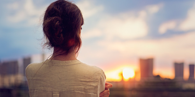 Young girl is watching sunset over Tokyo in Odaiba.