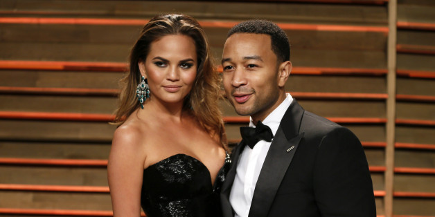 Singer John Legend and wife Chrissy Teigen arrive at the 2014 Vanity Fair Oscars Party in West Hollywood, California March 3, 2014. REUTERS/Danny Moloshok (UNITED STATES TAGS: ENTERTAINMENT) (OSCARS-PARTIES)