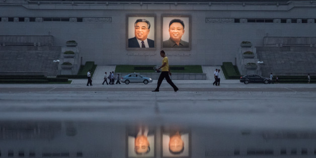 TOPSHOT - In a photo taken on July 21, 2017 pedestrians and vehicles pass before the portraits of late North Korean leaders Kim Il-Sung (L) and Kim Jong-Il (R) in Pyongyang.
China urged North Korea August 6 to make a 'smart decision', after the United Nations imposed tough new sanctions on the isolated regime over its missile and nuclear programmes. / AFP PHOTO / Ed JONES (Photo credit should read ED JONES/AFP/Getty Images)