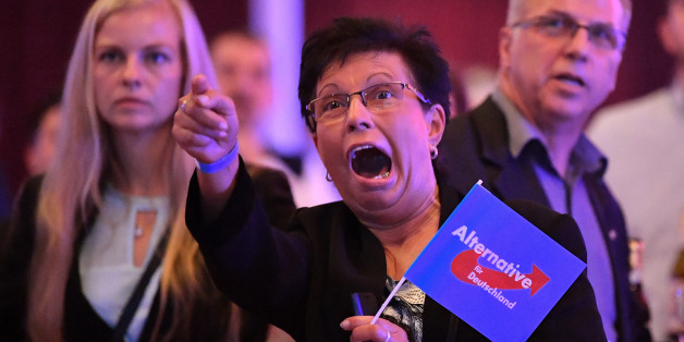 Supporters of the Alternative for Germany (AfD) react after exit poll results were broadcasted on public television at an election night event in Erfurt, eastern Germany during the general election on September 24, 2017.
The Alternative for Germany (AfD) became the first hard-right, openly anti-immigration party to enter parliament in force since World War II, breaking a taboo despite mainstream parties' calls to halt 'the Nazis' in their tracks. / AFP PHOTO / dpa / Martin Schutt / Germany OUT (Photo credit should read MARTIN SCHUTT/AFP/Getty Images)