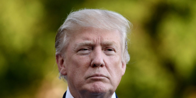 U.S. President Donald Trump listens to members of the media on the South Lawn after returning to the White House in Washington, D.C., U.S., on Saturday, Sept. 24, 2017. Trump accelerated his criticism of the National Football League on Sunday by saying fans should consider not going to games, sparking strong objections from players and owners including a longtime friend and contributor. Photographer: Olivier Douliery/Pool via Bloomberg