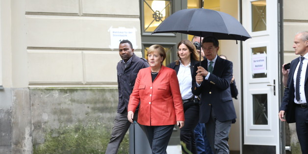 BERLIN, BERLIN-MITTE, GERMANY - 2017/09/24: Angela Merkel and Joachim Sauer on the way to a polling station with umbrella. They are voting in the 2017 Bundestag election at Wahllokal 108, student center Mensa Süd at the Humboldt University of Berlin. (Photo by Simone Kuhlmey/Pacific Press/LightRocket via Getty Images)