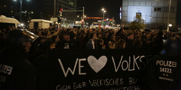BERLIN-MITTE, BERLIN, GERMANY - 2017/09/24: Police officers stand in front of protesters with banners. Hundreds of protesters gathered outside a club near the central Alexanderplatz in Berlin that was the venue of the election night party of the right wing AfD (Alternative for Germany) party. They protested against the election victory of the party which gained nearly 13% of the votes. The venue was was protected by a large number of riot police officers. (Photo by Michael Debets/SOPA Images/LightRocket via Getty Images)