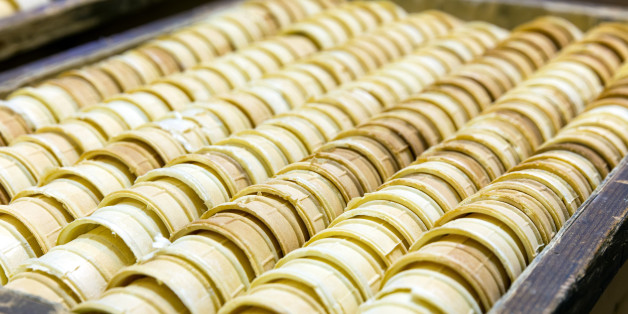 Many empty waffle cones for ice cream in a box