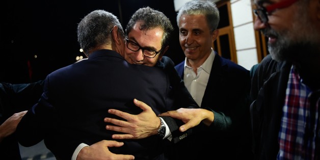 Turkish cartoonist Musa Kart (L) embraces Kadri Gursel (2nd L) as the representative of the international rights group Reporters Without Borders (RSF) in Turkey, Erol Onderoglu (R), holds his hand after the Gursel's release from Silivri prison on September 26, 2017 in Istanbul, following a Turkish court order to free the columnist and editorial director of Turkey's opposition newspaper Cumhuriyet.
An Istanbul court on Monday ordered the release of the leading journalist in the controversial trial of staff from the Cumhuriyet opposition newspaper, but ruled that four other detained suspects must stay in jail. / AFP PHOTO / YASIN AKGUL (Photo credit should read YASIN AKGUL/AFP/Getty Images)