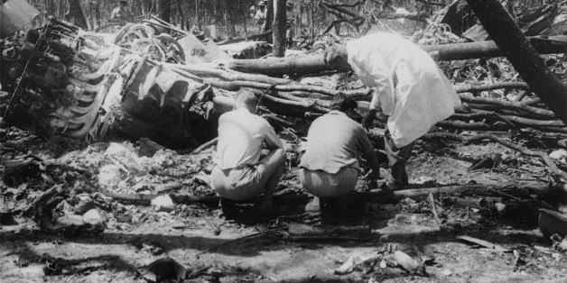 Officials search the crash site after the plane carrying Swedish diplomat Dag Hammarskjold (1905 - 1961), Secretary-General of the United Nations, came down near Ndola in Northern Rhodesia (later Zambia), resulting in his death, September 1961. Hammarskjold was on his way to negotiate a ceasefire with President Moise Tshombe of Katanga. (Photo by Central Press/Hulton Archive/Getty Images)