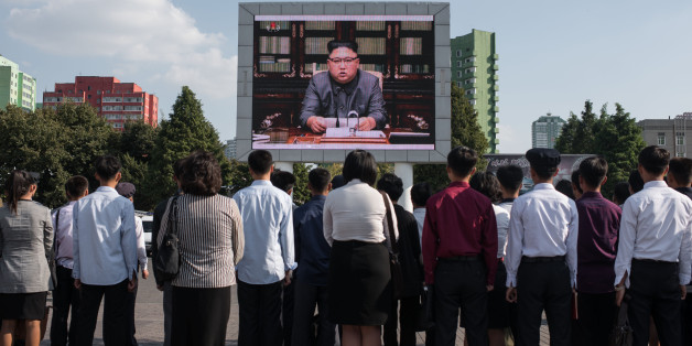 TOPSHOT - Spectators listen to a television news brodcast of a statment by North Korean leader Kim Jong-Un, before a public television screen outside the central railway station in Pyongyang on September 22, 2017.US President Donald Trump is 'mentally deranged' and will 'pay dearly' for his threat to destroy North Korea, Kim Jong-Un said on September 22, as his foreign minister hinted the regime may explode a hydrogen bomb over the Pacific Ocean. / AFP PHOTO / Ed JONES (Photo credit shoul