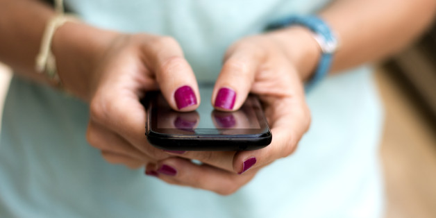 Girl holding smart phone outside