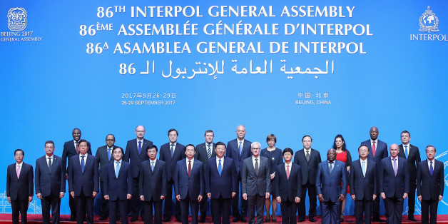 China's President Xi Jinping (front C), Interpol Secretary General Jurgen Stock (centre R) and Meng Hongwei (centre L), president of Interpol, pose for a group photo with various participants at the start of the 86th Interpol General Assembly at the Beijing National Convention Center in Beijing on September 26, 2017.
The assembly is taking place in the Chinese capital from September 26 to 29. / AFP PHOTO / POOL / Lintao Zhang (Photo credit should read LINTAO ZHANG/AFP/Getty Images)
