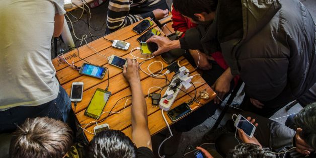 Migrants charge their mobile phones in a restaurant near the central bus station in Belgrade, on March 24, 2017.
Repelled by police batons and snarling dogs, or beaten and robbed by the smugglers they relied on, migrants caught in Serbia have regularly been victims of violence as they try to reach Europe. About 8,000 migrants have been trapped in the country since the European Union closed its borders, hoping to block the so-called Balkans route taken by hundreds of thousands of people fleeing the Middle East, Asia and Africa. / AFP PHOTO / OLIVER BUNIC (Photo credit should read OLIVER BUNIC/AFP/Getty Images)
