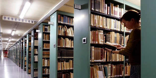 A woman consults a book in the library of the university KU Leuven "Katholieke Universiteit Leuven" in Leuven, Belgium, June 8, 2016. REUTERS/Francois Lenoir