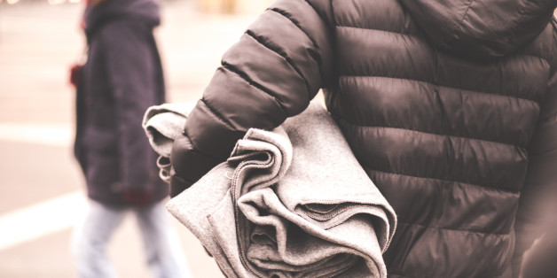 Migrants find shelter from rain and cold weather and warm your hands around the fire.