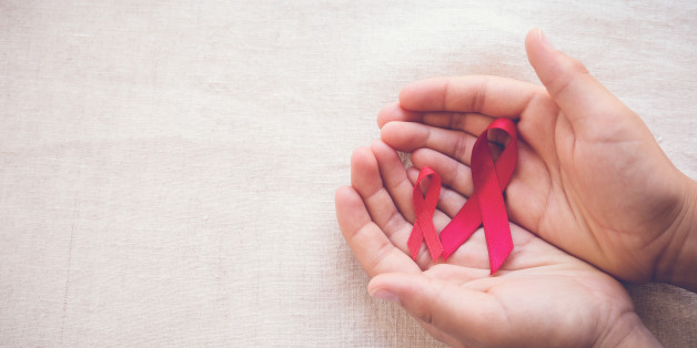hands holding Red Ribbons on toning background, HIV/AIDS, Anosmia, Heart disease,Epidermolysis bullosa and Vasculitis awareness