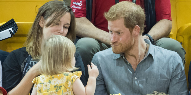 TORONTO, ON - SEPTEMBER 27: Prince Harry (R) sits with David Henson's wife Hayley Henson (L) and daugther Emily Henson at the Sitting Volleyball Finals on day 5 of the Invictus Games Toronto 2017 on September 27, 2017 in Toronto, Canada. The Games use the power of sport to inspire recovery, support rehabilitation and generate a wider understanding and respect for the Armed Forces. (Photo by Samir Hussein/WireImage)