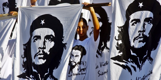 SANTA CLARA, CUBA - OCTOBER 8: Cubans hold flags with the image of Che Guevara during a commemoration of the 40th anniversary of the death of Ernesto Che Guevara October 8, 2007 in Santa Clara, Cuba. Guevara was killed October 8, 2007 in Bolivia after being captured by CIA backed Bolivian soldiers. (Photo by Sven Creutzmann/Mambo photo/Getty Images)