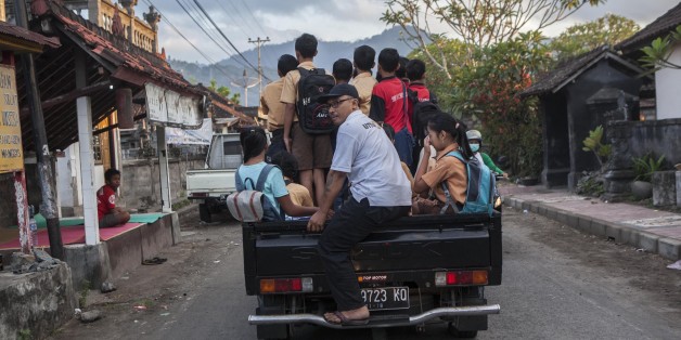 Student evacuated from their home due to the volcanic activities of Mount Agung, on a car as they head of school in a temporary shelter in in Karangasem regency, Bali, Indonesia, on September 29, 2017. Seismic activity below Mount Agung has been growing over recent weeks, with hundreds of tremors every day. Over the weekend, a plume of smoke has been seen rising from the crater. More than 134.000 people have fled the area around the crater and the alert was raised to the highest level on 22nd of September. (Photo by Agoes Rudianto/NurPhoto via Getty Images)