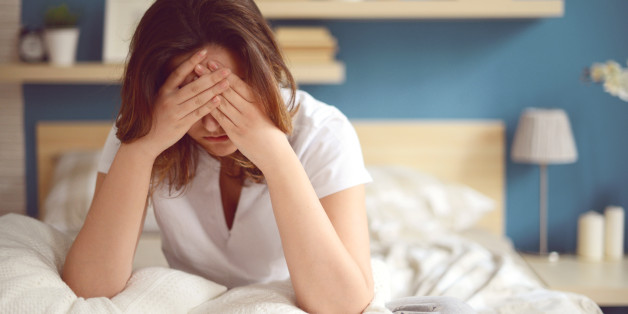 Unhappy girl in a bedroom