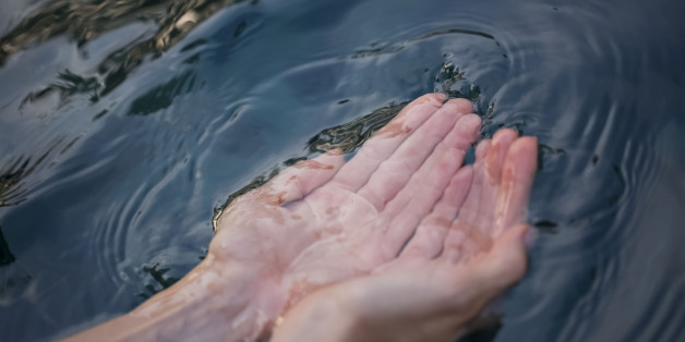 Human hands and clean water source, selective focus
