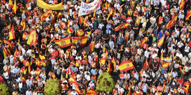 Protestors gather holding Spanish flags during a demonstration against independence of Catalonia called by DENAES foundation for the Spanish Nation Defence on September 30, 2017 in Madrid. Catalan separatists showed determination today to press ahead with an independence referendum banned by Madrid, occupying dozens of schools designated as polling stations to stop police from closing them down. / AFP PHOTO / GABRIEL BOUYS (Photo credit should read GABRIEL BOUYS/AFP/Getty Images)