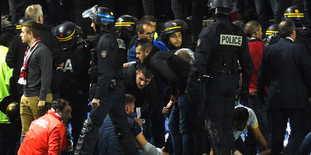 French police officers and members of the stadium staff gather to help LOSC's supporters following the fall of their tribune during the French L1 football match between Amiens and Lille LOSC on September 30, 2017 at the Licorne stadium in Amiens.
Several Lille supporters were hurt in Amiens when a stadium barrier collapsed in the away section as the visiting fans celebrated the opening goal of the match. The Ligue 1 fixture was interrupted in the 16th minute after Fode Ballo-Toure's goal sparked celebrations that caused a fence separating the fans from the pitch to crumble under their weight. Dozens of fans tumbled down on to the side of the pitch, crushed by fellow supporters, with medical staff quickly rushing to the scene to tend to those injured.
/ AFP PHOTO / FRANCOIS LO PRESTI (Photo credit should read FRANCOIS LO PRESTI/AFP/Getty Images)