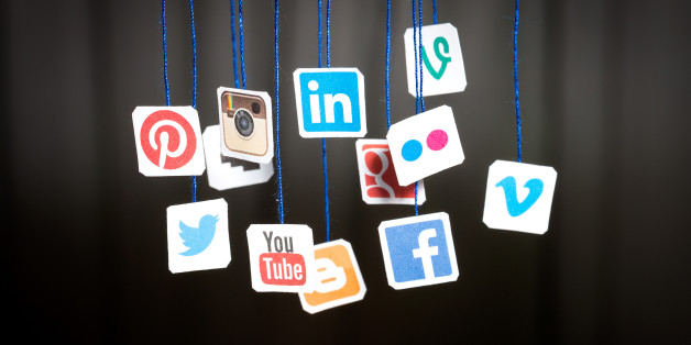BeÅchatów, Poland - August 31, 2014: Popular social media website logos printed on paper and hanging on strings.