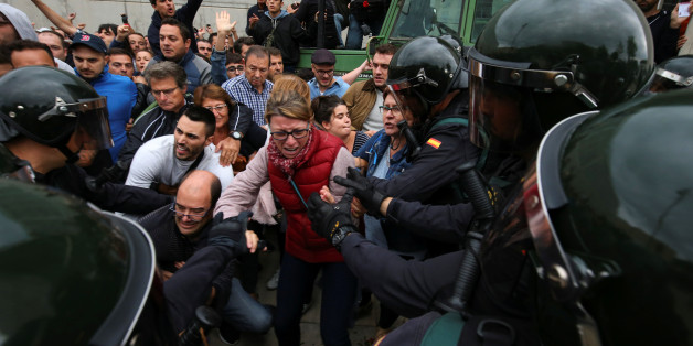Spanish Civil Guard officers disperse people outside a polling station for the banned independence referendum in Sant Julia de Ramis, Spain, October 1, 2017. REUTERS/Albert Gea TPX IMAGES OF THE DAY