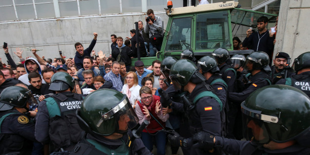 Scuffles break out between a crowd and Spanish Civil Guard officers, outside a polling station for the banned independence referendum, where Catalan President Carles Puigdemont was supposed to vote in Sant Julia de Ramis, Spain October 1, 2017. REUTERS/Albert Gea