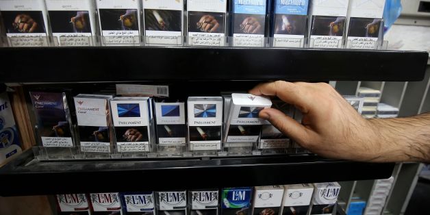 A picture taken on September 29, 2017 shows a close up shot of a vendor organizing cigarette boxes at a shop in Kuwait City.On October 1, 2017, the United Arab Emirates will double the price of tobacco and increase soft drink prices by 50 percent, ahead of a more general tax on goods and services on January 1 next year. It is but one of the six Gulf Cooperation Council states -- along with Saudi Arabia, Bahrain, Kuwait, Oman and Qatar -- to introduce the five-percent VAT next year as they seek t