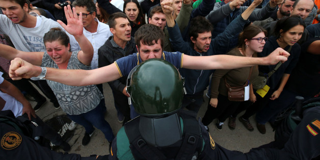 A man faces off with a Spanish Civil Guard officer outside a polling station for the banned independence referendum in Sant Julia de Ramis, Spain, October 1, 2017. REUTERS/Albert Gea