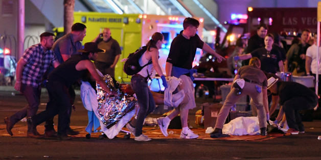 LAS VEGAS, NV - OCTOBER 02: An injured person is tended to in the intersection of Tropicana Ave. and Las Vegas Boulevard after a mass shooting at a country music festival nearby on October 2, 2017 in Las Vegas, Nevada. A gunman has opened fire on a music festival in Las Vegas, killing over 20 people. Police have confirmed that one suspect has been shot dead. The investigation is ongoing. (Photo by Ethan Miller/Getty Images)
