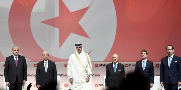 (LtoR) Algerian Prime Minister Abdelmalek Sellal: Tunisian Assembly President Mohamed Ennaceur; the Emir of Qatar, Tamim bin Hamad al-Thani; Tunisian President Beji Caid Essebsi, French Prime Minister Manuel Valls and Tunisian Prime Minister Youssef Chahed (R) stand on stage during the opening ceremony of the 'Tunisia 2020' international investment conference on November 29, 2016 in Tunis. France and Qatar promised billions of dollars of financial support to Tunisia at the launch Tuesday of a co