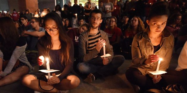 People attend a candlelight vigil at the University of Las Vegas student union October 2, 2017, after a gunman killed at least 58 people and wounded more than 500 others when he opened fire on a country music concert in Las Vegas, Nevada late October 1, 2017. / AFP PHOTO / Robyn Beck (Photo credit should read ROBYN BECK/AFP/Getty Images)