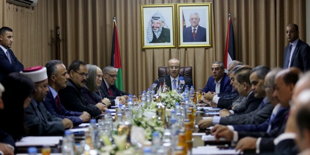 GAZA CITY, GAZA - OCTOBER 3: (----EDITORIAL USE ONLY MANDATORY CREDIT - ' PALESTINIAN PRESIDENCY / HANDOUT' - NO MARKETING NO ADVERTISING CAMPAIGNS - DISTRIBUTED AS A SERVICE TO CLIENTS----) Palestinian Prime Minister Rami Hamdallah (C) makes a speech during the first cabinet meeting in Gaza since unity government was established in 2014, in Gaza City, Gaza on October 3, 2017. (Photo by Palestinian Presidency / Handout/Anadolu Agency/Getty Images)