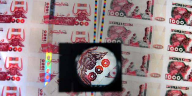 A picture taken on October 26, 2009 in Lyon, central France shows plates of false printed Algerian Dinar banknotes, shown during a press conference given after the police broke up a network of counterfeit currency. Twelve people were jailed and indicted on October 25, but the network has already used at least 200,000 banknotes of 1,000 dinars, or nearly 2 million Euros, said judicial police. AFP PHOTO PHILIPPE MERLE (Photo credit should read PHILIPPE MERLE/AFP/Getty Images)