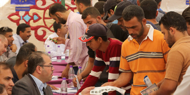 Syrian refugees queue to register their names at the Zaatari office for employment on October 4, 2017 at the Zaatari refugee camp, 80 kilometers (50 miles) north of the capital Amman.Around 50 companies at the EU-financed job fair, which Jordan's government and the United Nations refugee agency UNHCR opened on August 20, have been compiling lists of applicants by name, age and qualification. / AFP PHOTO / KHALIL MAZRAAWI (Photo credit should read KHALIL MAZRAAWI/AFP/Getty Images)