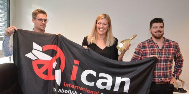 (From L) Nuclear disarmament group ICAN coordinator Daniel Hogstan, executive director Beatrice Fihn and her husband Will Fihn Ramsay pose with a banner bearing the group's logo after ICAN won the Nobel Peace Prize for its decade-long campaign to rid the world of the atomic bomb as nuclear-fuelled crises swirl over North Korea and Iran, on October 6, 2017 in Geneva.
With the nuclear threat at its most acute in decades, the International Campaign to Abolish Nuclear Weapons, which on October 6 won the Nobel Peace Prize, is urgently pressing to consign the bomb to history. / AFP PHOTO / Fabrice COFFRINI (Photo credit should read FABRICE COFFRINI/AFP/Getty Images)