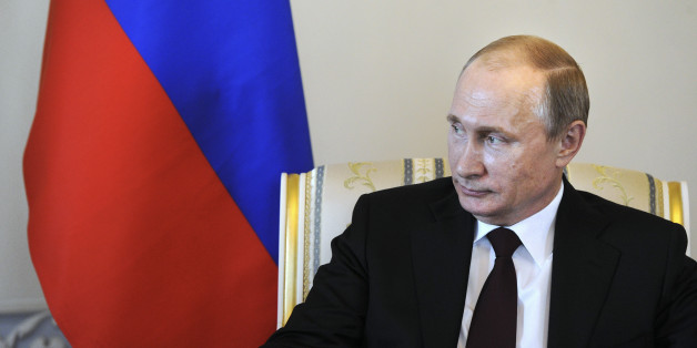 Russian President Vladimir Putin listens to his Kyrgyz counterpart Almazbek Atambayev (not pictured) during their meeting at the Constantine (Konstantinovsky) Palace in St. Petersburg March 16, 2015. Putin laughed off suggestions he had been forced to lie low because of poor health, saying on Monday that life would be "boring without gossip". REUTERS/Mikhail Klimentyev/RIA Novosti/Kremlin (RUSSIA - Tags: POLITICS) ATTENTION EDITORS - THIS IMAGE HAS BEEN SUPPLIED BY A THIRD PARTY. IT IS DISTRIBU