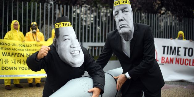 Picture taken on September 13, 2017 shows activists of the International campaign to abolish Nuclear Weapons (ICAN) wearing masks of US President Donald Trump (R) and North Korea's leader Kim Jong-un as they demonstrate in front of the US embassy in Berlin.The world's nuclear powers must begin 'serious negotiations' aimed at disarmament, the Nobel committee said on October 6, 2017 as it awarded its prestigious Peace Prize to non-proliferation pressure group ICAN. / AFP PHOTO / dpa / Britta Peder