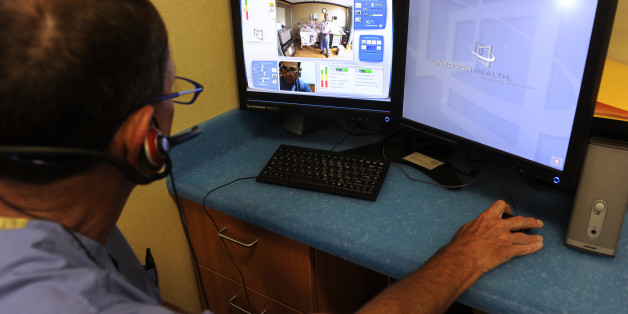 DENVER, CO - JULY 26: Dr. Jeff Hanson, left, a neonatologist at the Rocky Mountain Hospital for Children, talks with Dr. Jeff Brown at the Vail Valley Medical Center in Vail, CO. about Brown's patient, a 15-day-old infant. Dr. Brown's image can be seen on the top screen while Dr. Hanson's image appears below. Doctors in the NICU unit at the Rocky Mountain Hospital for Children are using telemedicine to video conference with doctors in rural and remote areas, such as Vail, CO, helping with medica