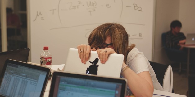 A student hides behind her laptop, laughing as she is studying with her peers in the Brody Learning Commons, a study space and library on the Homewood campus of the Johns Hopkins University in Baltimore, Maryland, 2015. Courtesy Eric Chen. (Photo by JHU Sheridan Libraries/Gado/Getty Images).