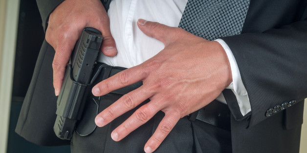 Security staff armed with handgun.