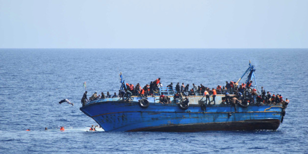 Migrants are seen on a capsizing boat before a rescue operation by Italian navy ships "Bettica" and "Bergamini" (unseen) off the coast of Libya in this handout picture released by the Italian Marina Militare on May 25, 2016. Marina Militare/Handout via REUTERS ATTENTION EDITORS - THIS PICTURE WAS PROVIDED BY A THIRD PARTY. FOR EDITORIAL USE ONLY. TPX IMAGES OF THE DAY