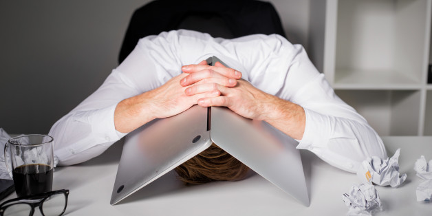Man hiding under laptop