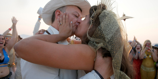 Burning Man participant Dustin Smith kisses his wife Rebecca Wyatt as they are married in the middle of the desert during the 4th day of the annual Burning Man arts and music festival in the Black Rock Desert of Nevada, U.S. August 31, 2017. Picture taken August 31, 2017. REUTERS/Jim Bourg FOR USE WITH BURNING MAN RELATED REPORTING ONLY. FOR EDITORIAL USE ONLY. NOT FOR SALE FOR MARKETING OR ADVERTISING CAMPAIGNS. NO THIRD PARTY SALES. NOT FOR USE BY REUTERS THIRD PARTY DISTRIBUTORS