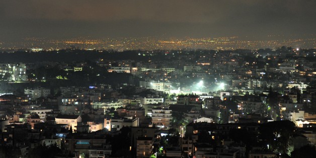 This picture taken on December 28, 2012 shows a line of smog over suburbs north west of Athens. Air pollution in Athens has surged in recent days because of people choosing wood over more expensive fuels to heat their homes in the grips of a continuing economic crisis, the environment ministry said today. Particulate matter has been measured at 150 milligrammes per cubic metre, or three times the danger level, especially in the northern and western suburbs of the Greek capital. 'The smog, which appears especially in the evening, is made up of polluting and dangerous particles that can cause respiratory problems,' said Evangelos Gerassopoulos, director of the Environment Institute of the Athens Observatory. AFP PHOTO / LOUISA GOULIAMAKI (Photo credit should read LOUISA GOULIAMAKI/AFP/Getty Images)