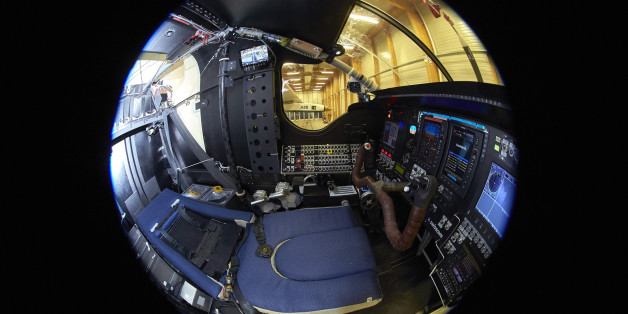 The pilot seat is pictured in the sleep position in the cockpit of the solar-powered Solar Impulse 2 aircraft is pictured after a training flight at its base in Payerne November 8, 2014. From left to right instruments are : fuses, throttle, power management, autopilot, motor control, flying instruments and telecomunication. The aircraft, which was unveiled April 9, weighs 2.4 tons with a wingspan of 72 meters (236 ft.) and more than 17,000 solar cells. The attempt to fly around the world in stages using only solar energy will be made from March 2015 starting from Abu Dhabi. Picture taken with a fisheye lens. REUTERS/Denis Balibouse (SWITZERLAND - Tags: TRANSPORT ENVIRONMENT SCIENCE TECHNOLOGY)